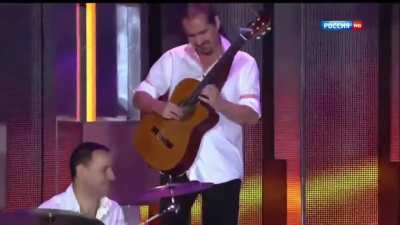 This guy is "playing" Electric guitar on acoustic...