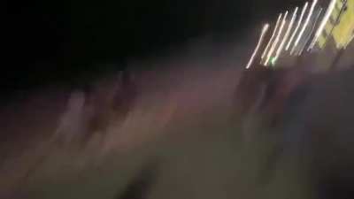 Spring breakers run as SWAT team moves to disperse a crowd in Miami Beach, FL.
