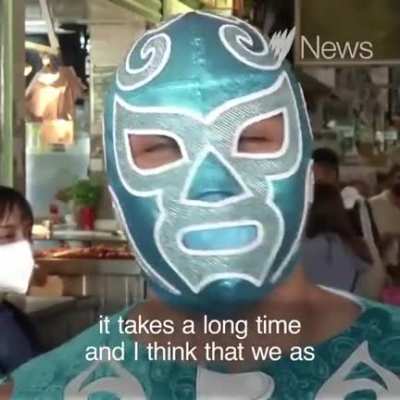 Professional wrestlers enforce the face mask rule at the Central de Abastos market in Mexico City.