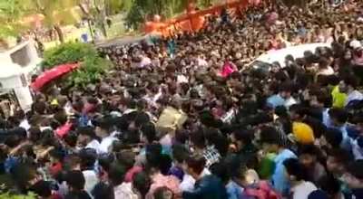 A stampede of men forcing their way into a women's college in Delhi