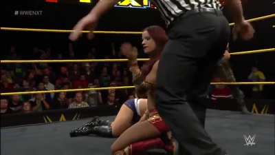 Sasha drags Alexa to the center of the ring by her blonde hair, applies The Bank Statement and refuses to let go even after Alexa taps! Poor Alexa is reduced to screaming &ldquo;Ref!&rdquo; for help!