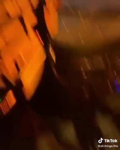 Protestors throwing rocks at firefighters.