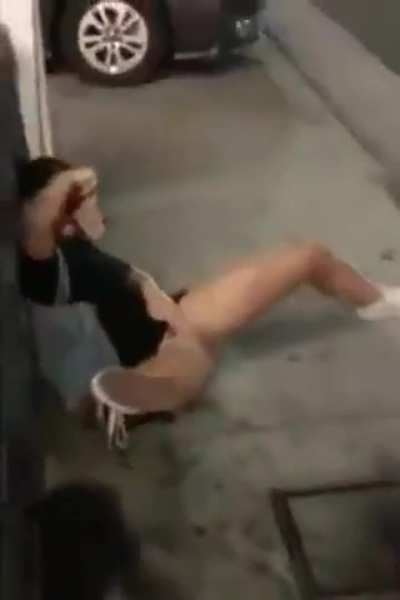 Two girls peeing along a busy street