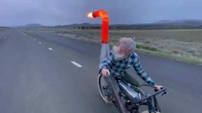 Man riding a jet-powered bicycle