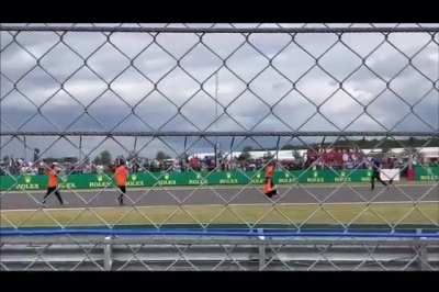 Protesters on track at Silverstone F1 race.