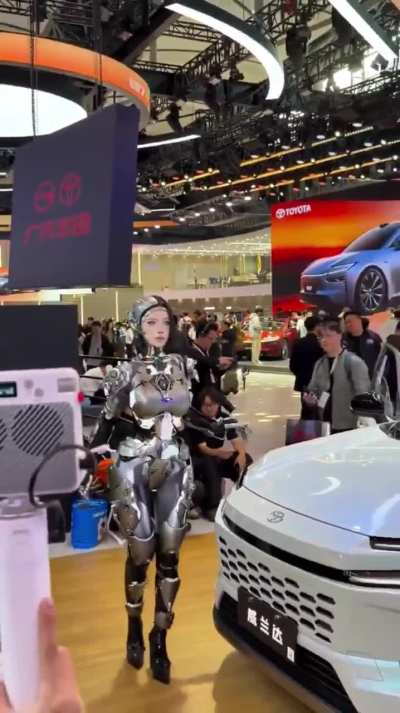 Yes, this is a real human inside a robotic suit, and it&rsquo;s insanely realistic. She&rsquo;s been blowing people&rsquo;s minds at recent tech expos in China, and no matter how much I dig, I can&rsquo;t find who the performer actually is. Anyone know?