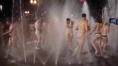 Playing in a fountain completely naked
