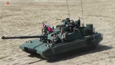 Kim Jong Un sits atop a battle tank during war drills , Joined by his daughter