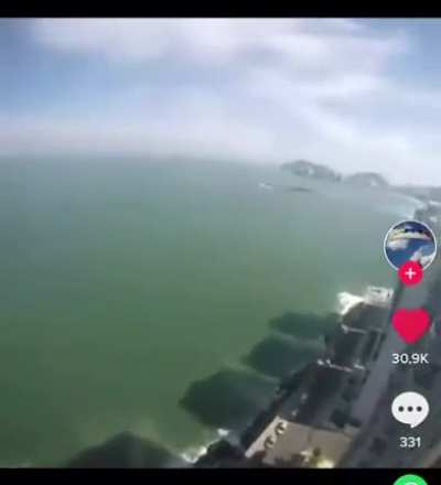 Paraglider casually catching a beer in Brazil