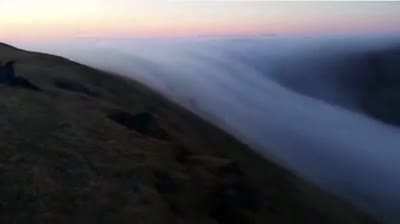 An ethereal waterfall created by a river of fog flowing over the cliffs of L&aacute;trabjarg, Iceland, a stunning example of katabatic wind; the downslope flow of cold, dense air under the force of gravity. Credit: Kjartan Gunnsteinsson