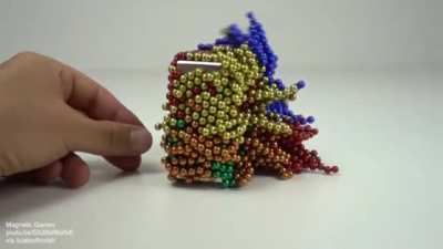Collision of monolith magnet and 1728 magnetic balls