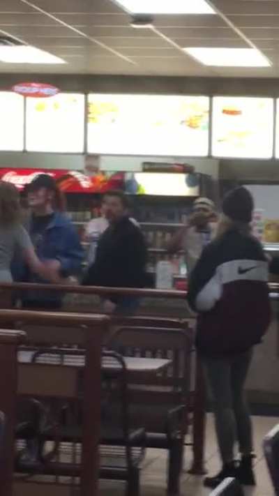 Drunk girl tries to throw hands with a cop standing behind her in line