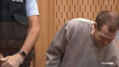 An uncommon clip of Brenton Tarrant smiling in court