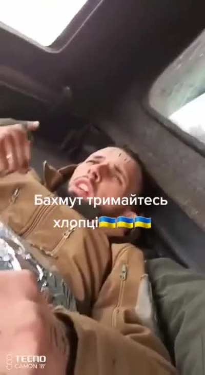 An injured Ukrainian soldier gets evacuated from Bakhmut. Meanwhile, he tells the other soldier filming: "I will soon be a father, and I love my wife; I am not going to die!"