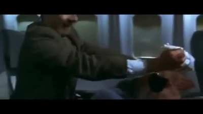 Mr.bean popping a bag on a plane