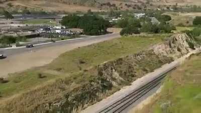 Motorcyclist jumps across train tracks as the police tries to stop them