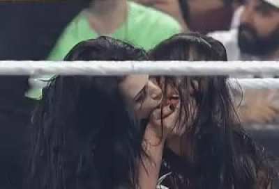 Paige kissing AJ after dominating her