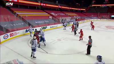 Muzzin flips a puck at Tkachuk after the game ends