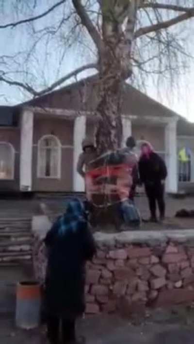 Man and woman caught looting a fallen Ukrainian soldier&rsquo;s home by the entire village in Zhytomyr.