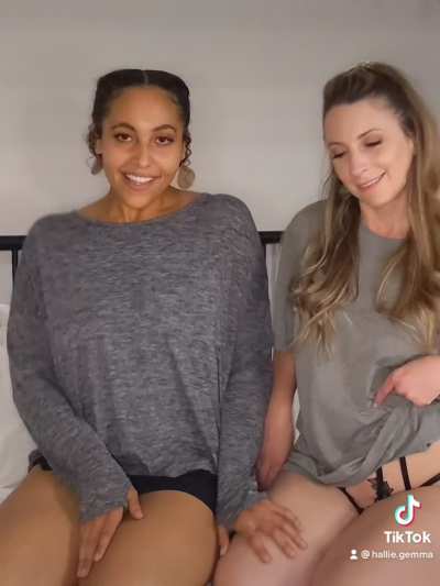 Two beautiful women kiss