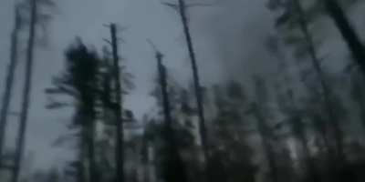 A Russian tank is hit with cluster munitions and the crew dismounts. Filmed from the tank crew's POV. Kreminna forest, Jan 2024.