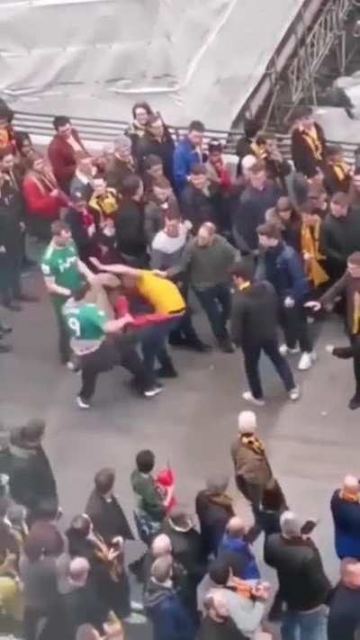 A Wolves fan is randomly attacking Watford fans.
