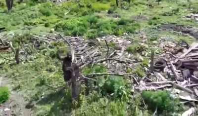 African mercenary(?) of the Russian army fighting off a Ukranian drone with a stick