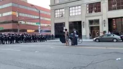 The moment a line of U.S. security forces act as a firing squad to shoot a small young woman holding an anti-street execution sign. They don't care if you are peaceful. Spread the video please.