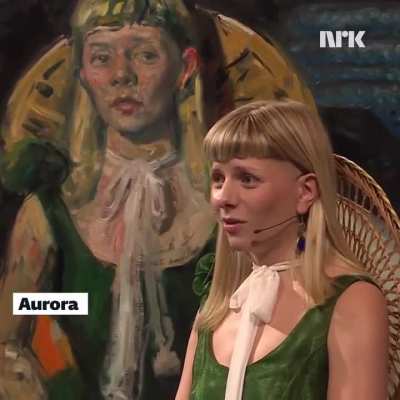 Aurora is stunned by her portrait, painted by Vebj&oslash;rn Sand and Bj&oslash;rg Thorhallsdottir. Sold for 323 000 Norwegian kroner in connection with TV aksjonen 2025. Money went to the Atlas Alliance.

Source: NRK.