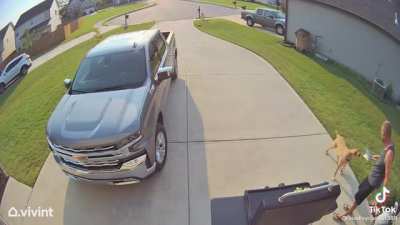 Sales woman runs to a man in fear of a friendly dog