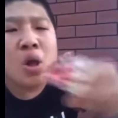 Man eating lit cigarettes by the fistful