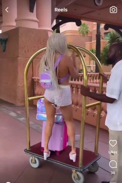 The workers look so annoyed. The one guy even shakes his head &ldquo;no&rdquo; when she&rsquo;s on the luggage cart