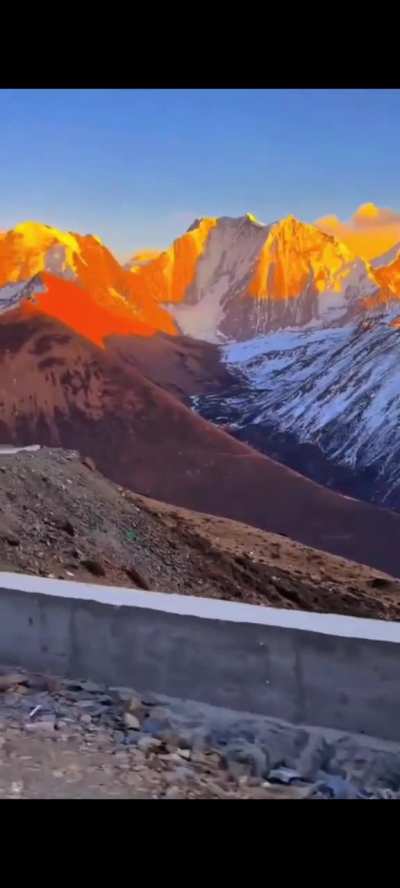 Sunrise lighting up snow capped mountains