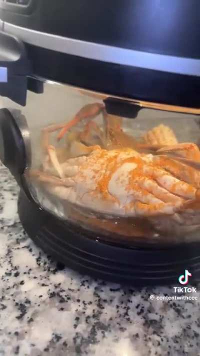 Person air frying live crabs
