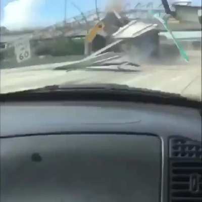 Truck drives into highway sign