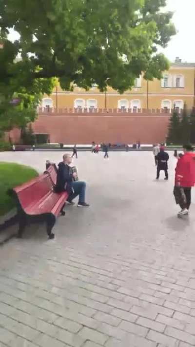 Russian civilian playing "Oh, in the meadow red viburnum" under the walls of Kremlin.