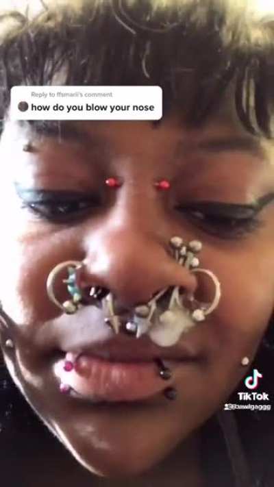 Blowing her nose