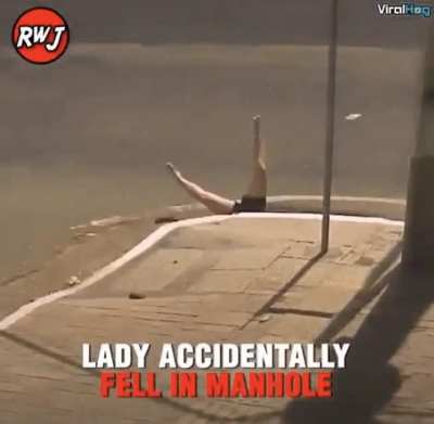 Hmm... Lady regretting inside a manhole.