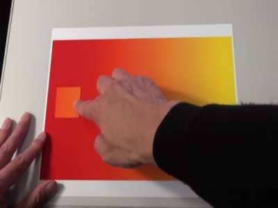 Your eyes see color by contrasting it with other colors, so when the square slides back and forth it appears to change color.