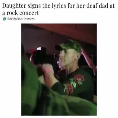 Girl signs the lyrics for her dad at a music concert