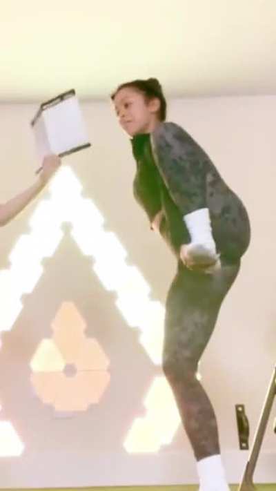Liza Koshy stretching for a workout