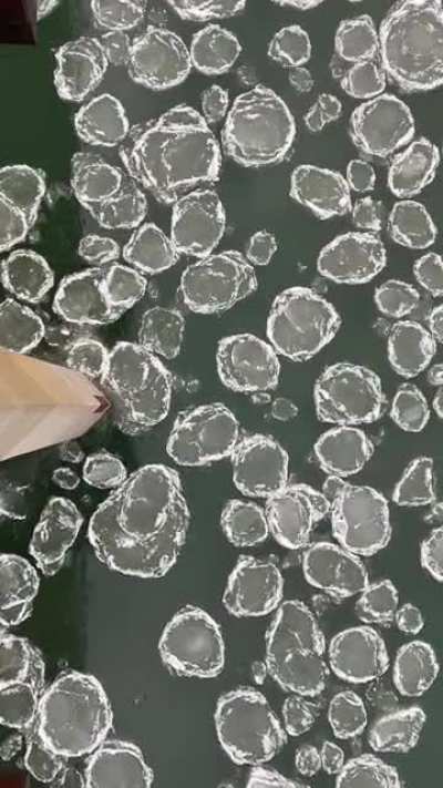 Ice pads breaking against bridge