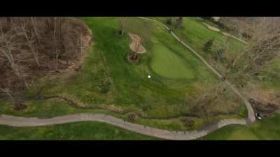 (tracking a golf ball) Maybe he'll hit the green next time.