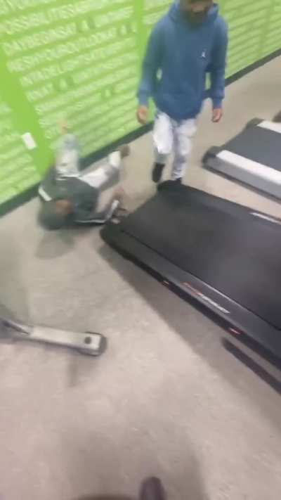 Kid tried to get on a rolling treadmill. 