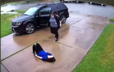 The girl in blue was having an anxiety attack. She called her mom, when her mom arrived she found her laying on the driveway in the rain. Instead of getting mad she gets down held her daughter&rsquo;s hand and laid with her&hellip; in the rain&hellip; until her anxiety passe