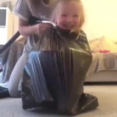 Vaccum, garbage bag and a child, what a perfect combo
