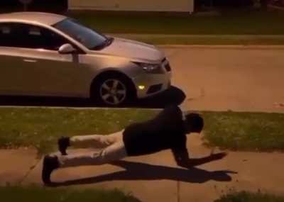 Man does a full front flip from an incline plank position