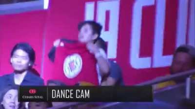 This kid baiting the broadcast into flashing a "Fight for freedom stand with Hong Kong" sign on TV