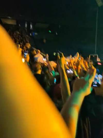Wes crowd surfing while playing Faith.