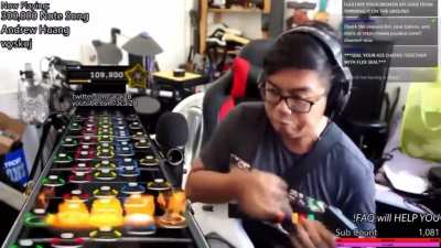 Brown man nearly breaks guitar and fingers playing impossible song.